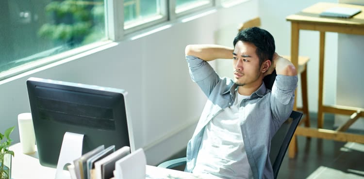 Serious man looking at computer monitor