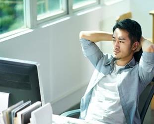 Serious man looking at computer monitor