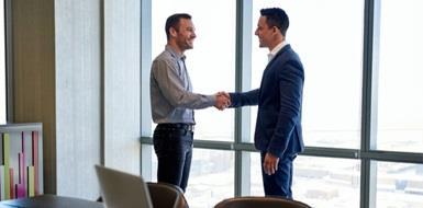 Two men shaking hands in an office
