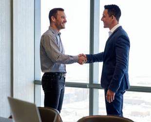 Two men shaking hands in an office