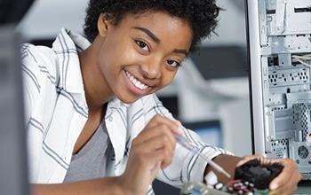 Woman fixing a computer