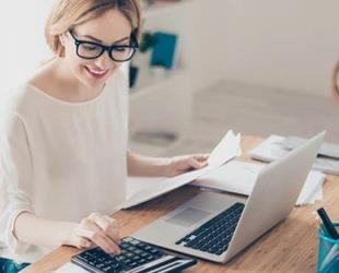 A woman using her calculator to determine consulting fees