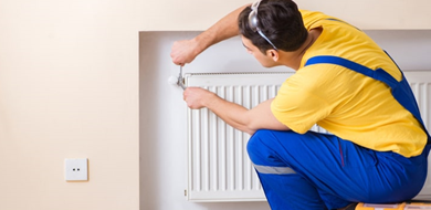 A handyman fixes a vent in a house