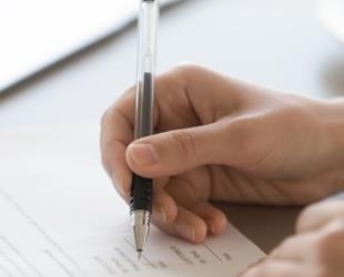 Business person signing license paperwork