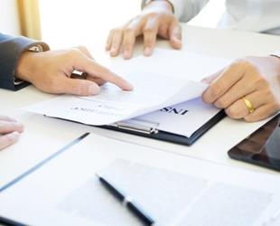 Two people reading a certificate of insurance form