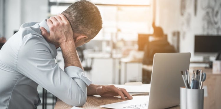 A patient reviewing their workers' compensation insurance policy on their laptop