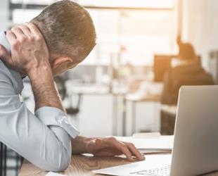 A patient reviewing their workers' compensation insurance policy on their laptop