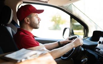 delivery man driving work vehicle