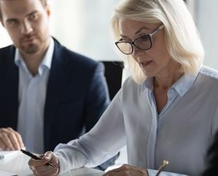 Person signing insurance and bonding documents.