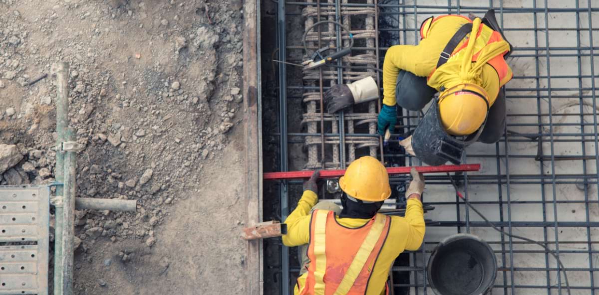 Construction contractors measuring the surface area of a work site. Construction contractors measuring the surface area of a work site.