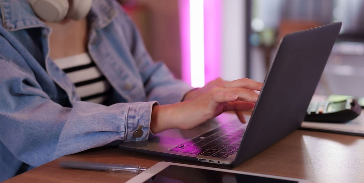 Person typing on a laptop computer at a desk. Person typing on a laptop computer at a desk.