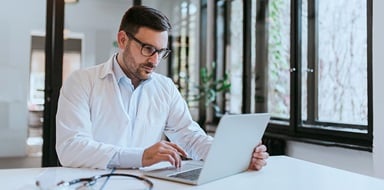 Person reviewing hipaa breach insurance on a laptop.