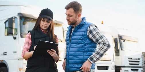Two people reviewing a trucking contract.