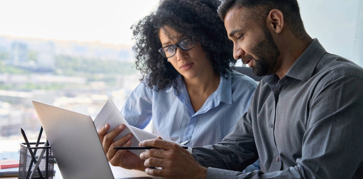 Two coworkers reading a document. Two coworkers reading a document.