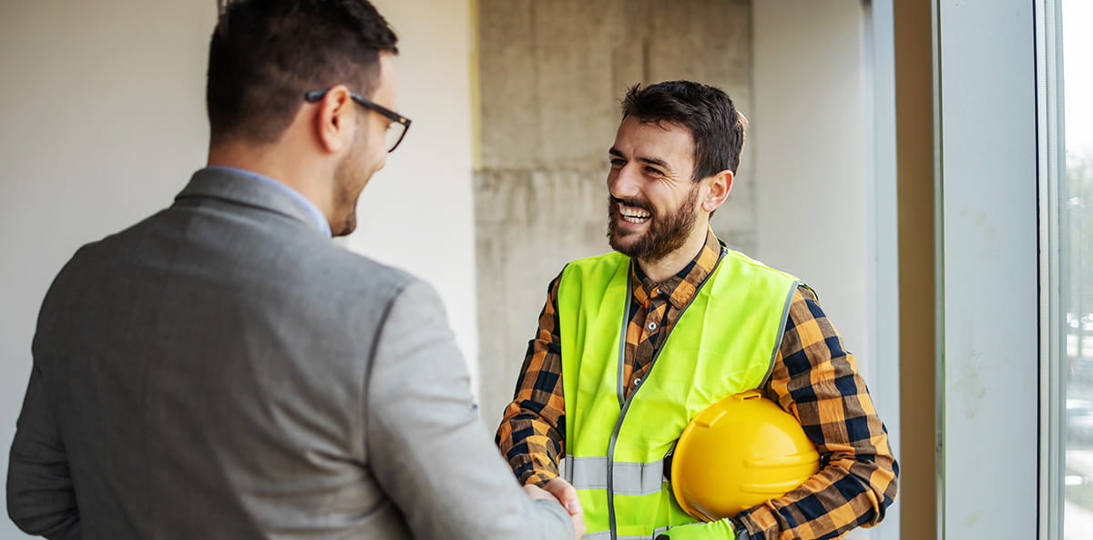 Engineer and business professional shaking hands.