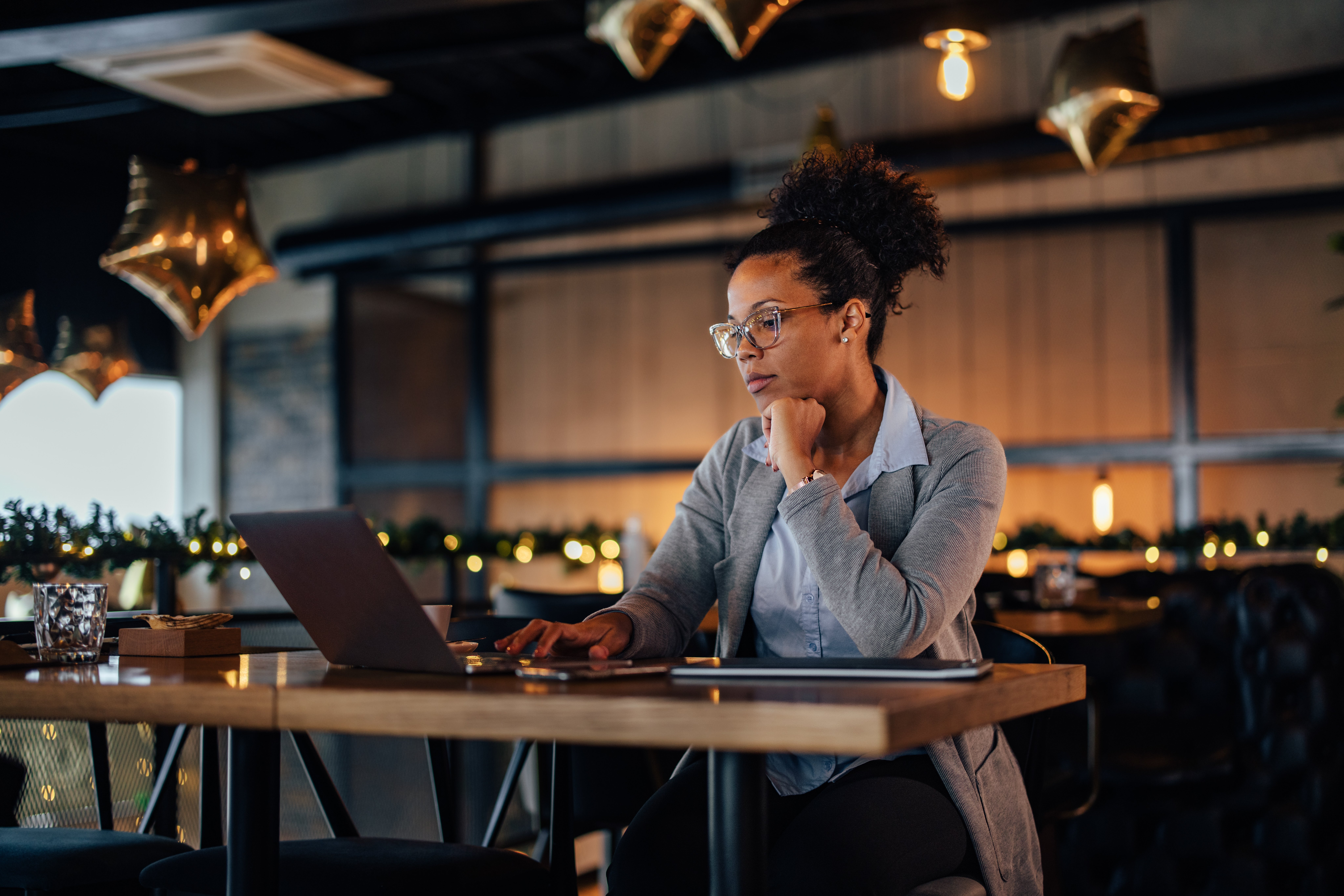 Small business owner working on a laptop in a restaurant. Small business owner working on a laptop in a restaurant.