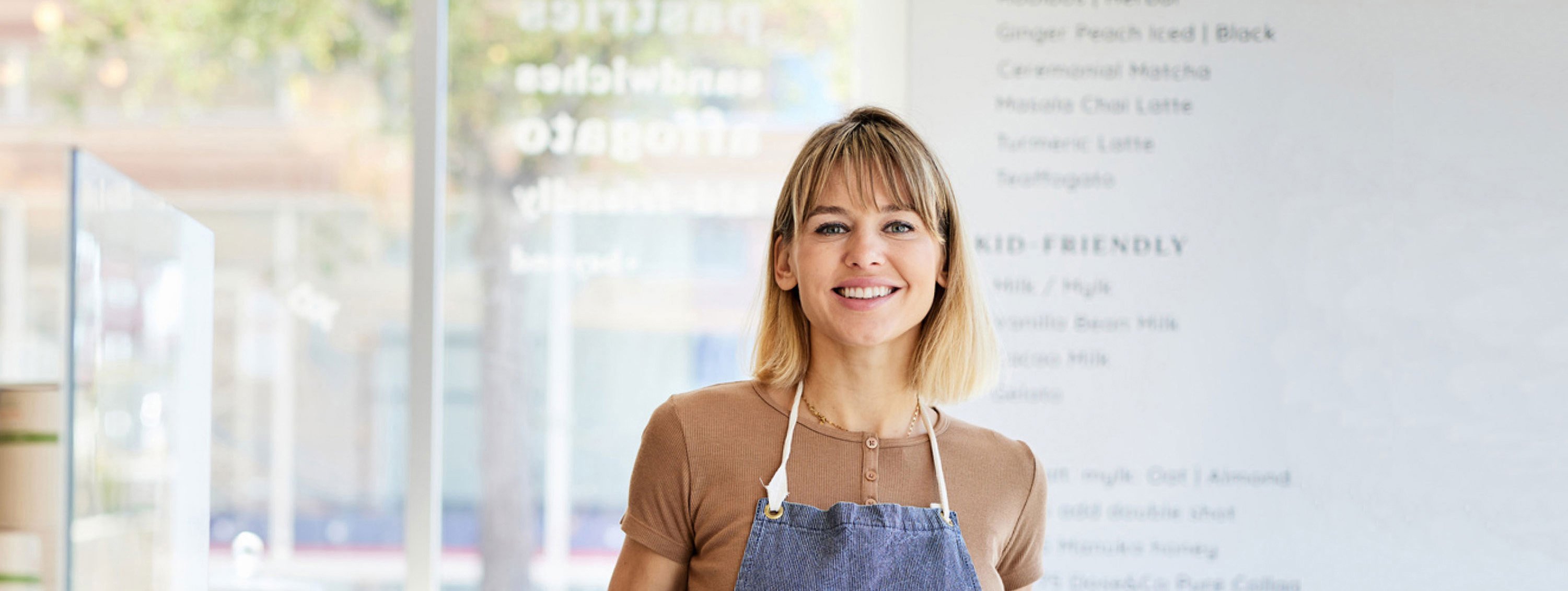 Person in apron standing in store.