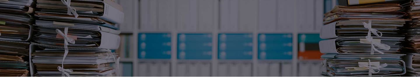 Desk piled high with files.