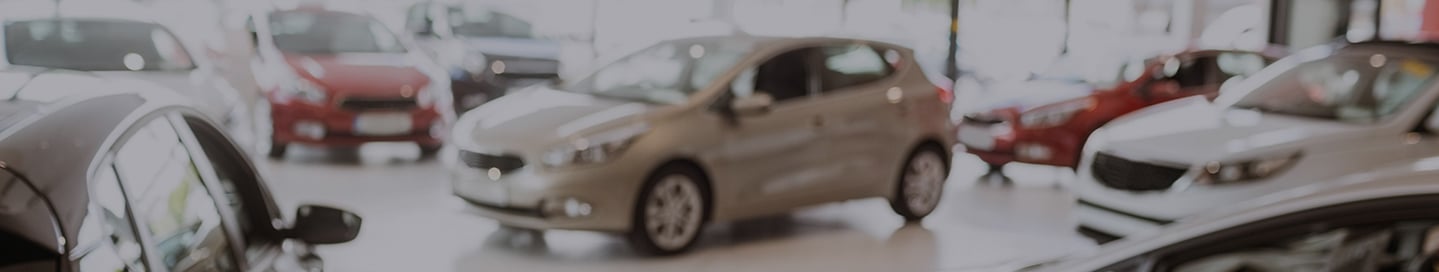 Cars in the showroom at a dealership.