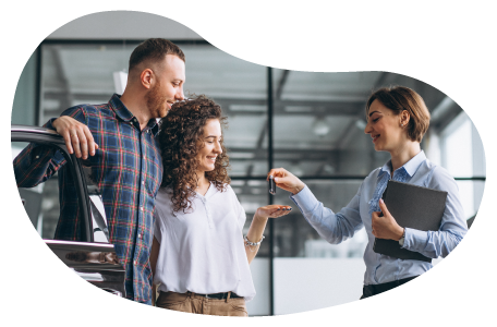 A car dealer handing the keys to two buyers.