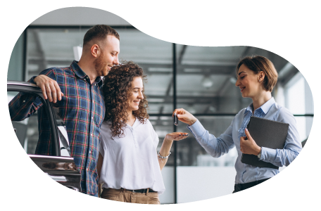 A car dealer handing the keys to two buyers. A car dealer handing the keys to two buyers.