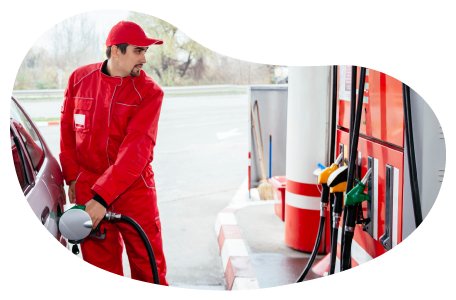 Gas station attendant fueling a car.