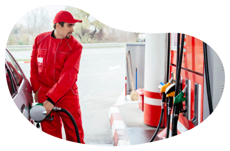 Gas station attendant fueling a car. Gas station attendant fueling a car.