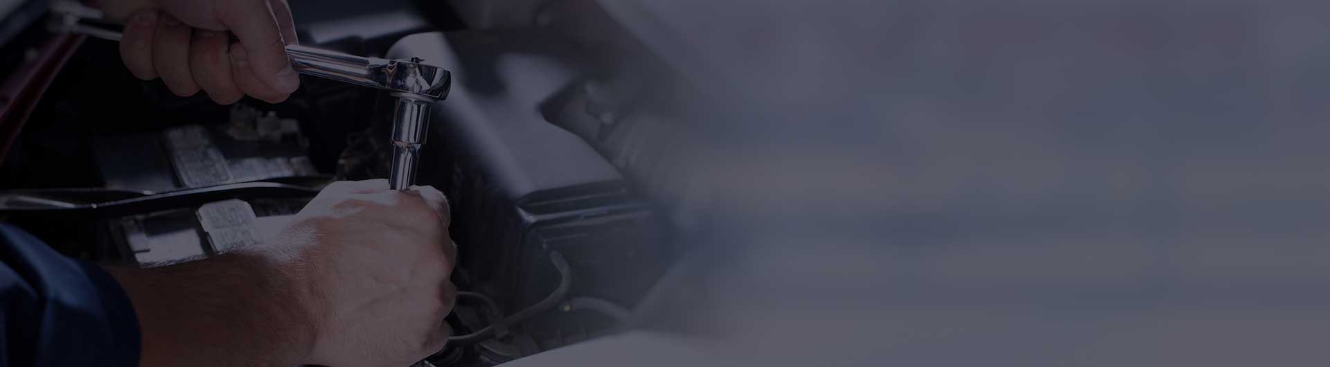 Hands of car mechanic in auto repair service.