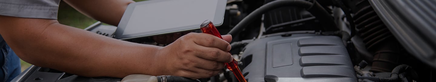 Mobile mechanic inspecting a client's engine. Mobile mechanic inspecting a client's engine.