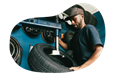 Tire shop employee working on a customer's car.