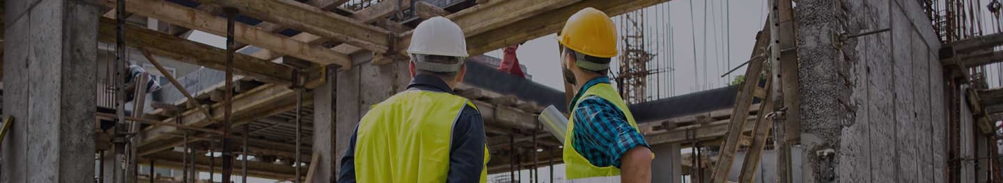 Two men looking at progress of construction of a building.