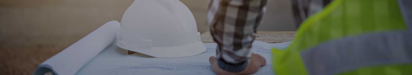 Engineer reviewing plans at a work site. Engineer reviewing plans at a work site.