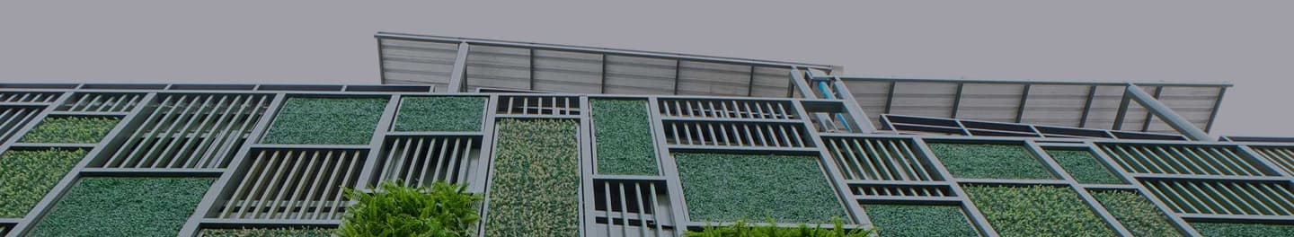 View of a tall building with greenery.