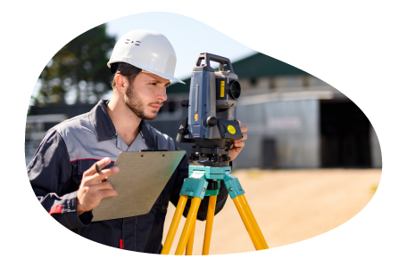 Land surveyor observing a plot of land. Land surveyor observing a plot of land.