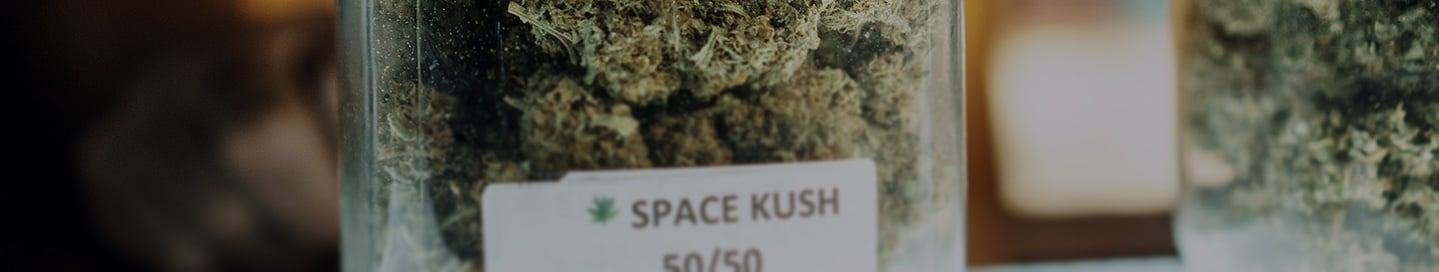 A jar of "Space Kush" marijuana on the shelf of a dispensary. A jar of "Space Kush" marijuana on the shelf of a dispensary.