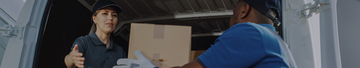 Cannabis transportation employees load cannabis products onto a truck.