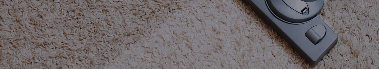 Vacuum cleaner on a beige carpet.