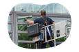 A contractor cleans the exterior of an office building.