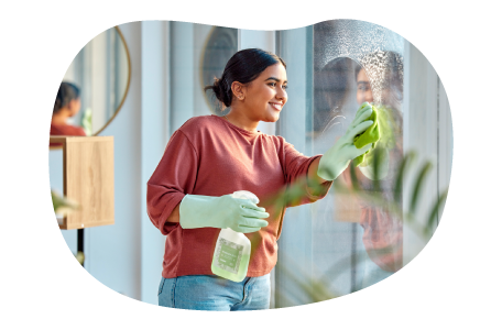 House cleaner washing a client's windows. House cleaner washing a client's windows.