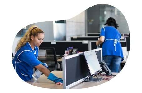 Janitorial professionals cleaning office desks.