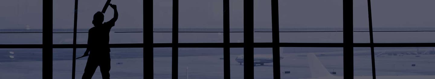 Man cleaning large commercial windows Man cleaning large commercial windows