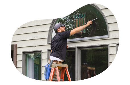 Window cleaner wiping a client's window.