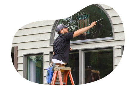 Window cleaner wiping a client's window. Window cleaner wiping a client's window.