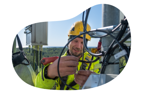 A cell tower technician performs routine maintenance. A cell tower technician performs routine maintenance.