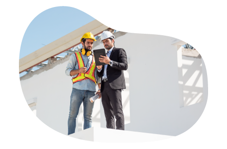 Commercial builder and client looking at blueprints.