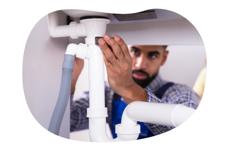 A drain cleaning contractor examines a new plumbing fixture.