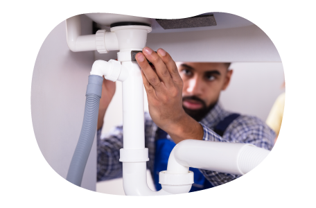 A drain cleaning contractor examines a new plumbing fixture. A drain cleaning contractor examines a new plumbing fixture.