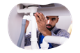 A drain cleaning contractor examines a new plumbing fixture.
