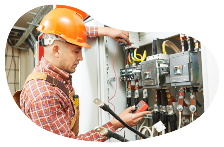 Electrician inspecting the wiring on a circuit breaker. Electrician inspecting the wiring on a circuit breaker.