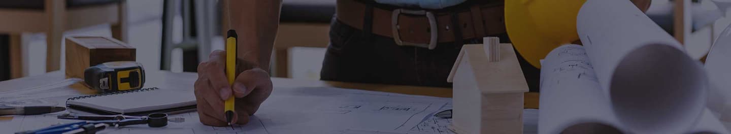 General contractor reviewing plans at a table.